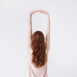 woman-in-beige-dress-stretching-her-hands-709791